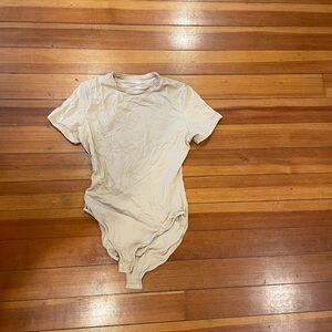 Skims cream colored bodysuit. Size large.